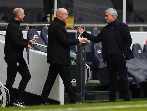 Jose Mourinho (R), Manager of Tottenham Hotspur interacts with Sean Dyche, Manager of Burnley prior to the Premier League match between Tottenham Hotspur and Burnley at Tottenham Hotspur Stadium on February 28, 2021 in London, England.