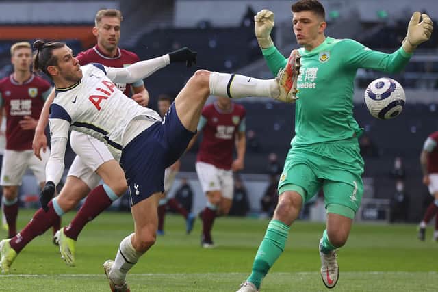 Gareth Bale of Spurs goes for the ball with keeper Nick Pope of Burnley during the Premier League match between Tottenham Hotspur and Burnley at Tottenham Hotspur Stadium on February 28, 2021 in London, England.