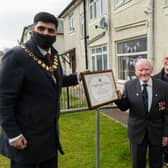 Burnley Mayor Coun. Wajid Khan presenting the Certificate of Honour to Mr Stephen Bacon, watched by his proud daughter and son-in-law