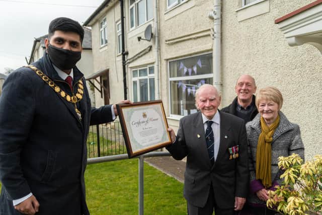 Burnley Mayor Coun. Wajid Khan presenting the Certificate of Honour to Mr Stephen Bacon, watched by his proud daughter and son-in-law