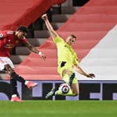Manchester United's English striker Marcus Rashford (L) shoots to score the opening goal under pressure from Newcastle United's Swedish defender Emil Krafth (R) at Old Trafford in Manchester, north west England, on February 21, 2021.