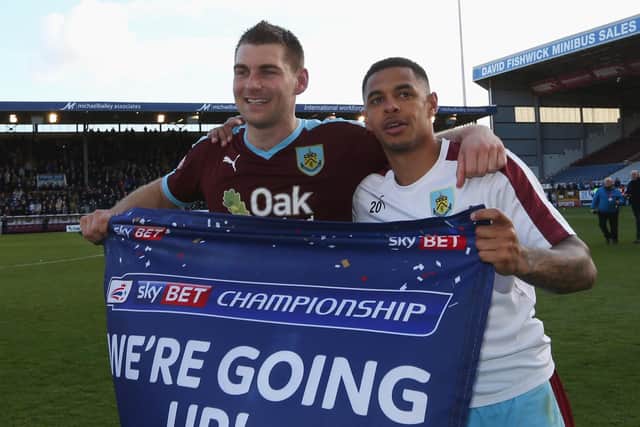 Sam Vokes (9) and Andre Gray of Burnley (7) celebrate as they are promoted to the Premier League after the Sky Bet Championship match between Burnley and Queens Park Rangers at Turf Moor on May 2, 2016 in Burnley, United Kingdom.
