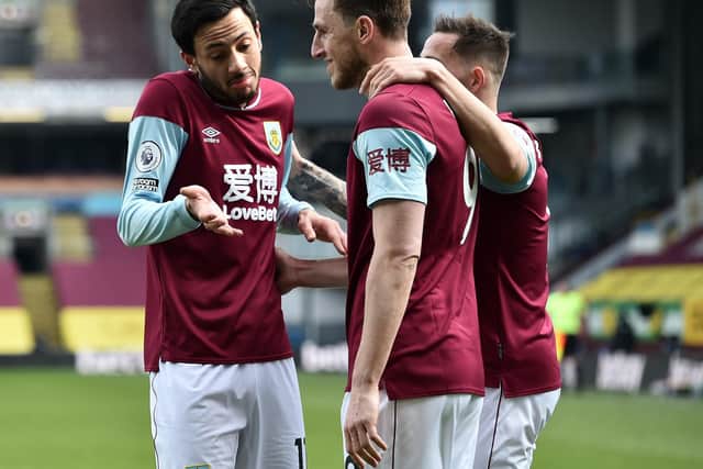 Chris Wood of Burnley celebrates with teammates Dwight McNeil and Josh Brownhill after scoring his team's first goal during the Premier League match between Burnley and Arsenal at Turf Moor on March 06, 2021 in Burnley, England.