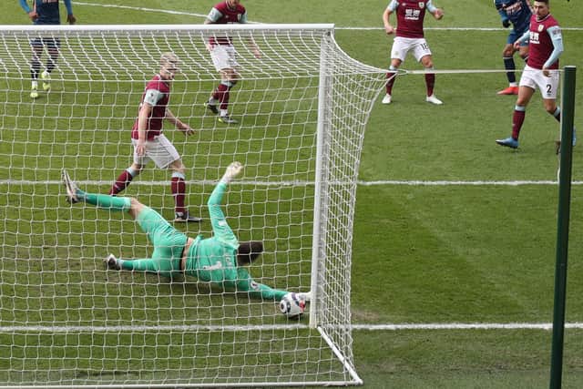 Arsenal's Gabonese striker Pierre-Emerick Aubameyang (top R) watches as his shot beats Burnley's English goalkeeper Nick Pope at his near post for the opening goal at Turf Moor in Burnley, north west England on March 6, 2021.