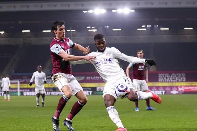 Kelechi Iheanacho of Leicester City crosses past Jack Cork of Burnley during the Premier League match between Burnley and Leicester City at Turf Moor on March 03, 2021 in Burnley, England.