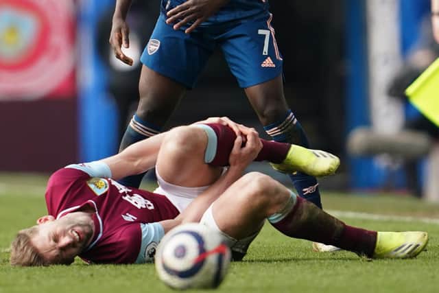 Burnley's English defender Charlie Taylor lies injured on the field during the English Premier League football match between Burnley and Arsenal at Turf Moor in Burnley, north west England on March 6, 2021.