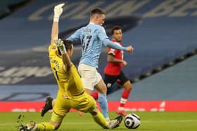 Phil Foden is brought down by Alex McCarthy