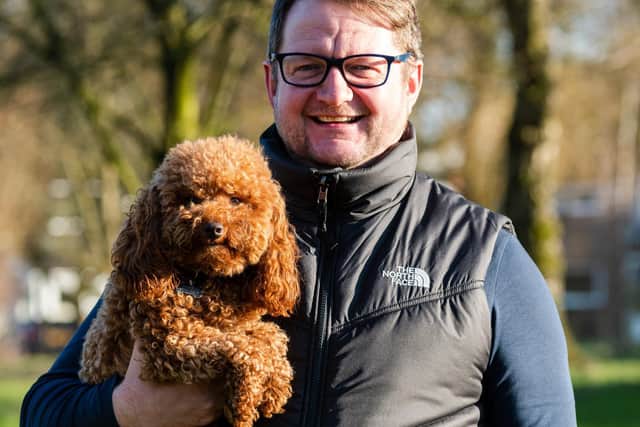 Gavin with the family pet, toy poodle Malcolm, who is as well known as Gavin around Padiham