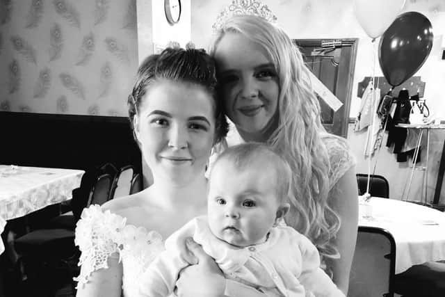 Lucy (left) and Leanne Devine with their daughter Faith on their wedding day two years ago