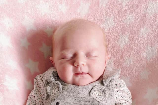 Baby Hope Devine escaped serious harm when a rock was thrown through the window of her home and bounced off the swing chair she was sleeping in
