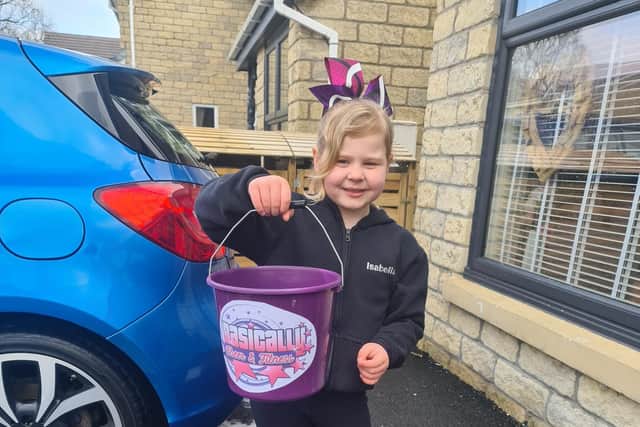 Isabella Dale (seven) raised £100 for her dance school by washing cars