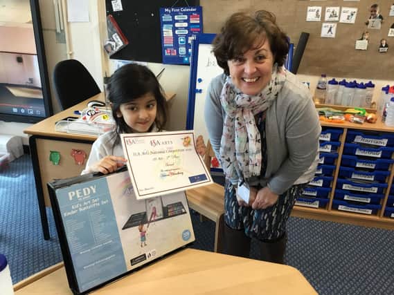 Hanna is presented with a certificate from teacher Susana Hannah