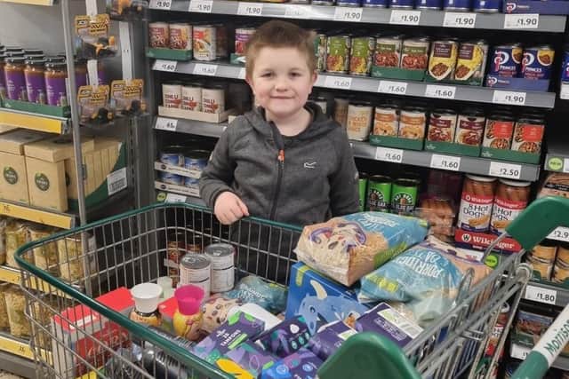 Alfie with some of the food he bought to donate to vulnerable families to help them through the pandemic