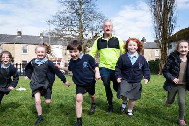 Charlie Briggs gets in training for the London Marathon with the help of Burnley youngsters (left to right)  Naomi Rochester, Sadie Phillipson, Jamie Woods ,Ruby Jephcott and Amelia Fenemore