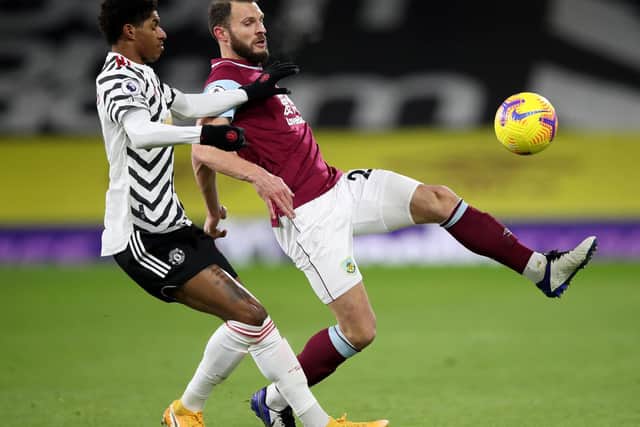 Manchester United's English striker Marcus Rashford (L) vies with Burnley's Dutch defender Erik Pieters during the English Premier League football match between Burnley and Manchester United at Turf Moor in Burnley, north west England on January 12, 2021.
