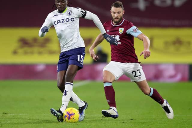 Bertrand Traore of Aston Villa is challenged by during the Premier League match between Burnley and Aston Villa at Turf Moor on January 27, 2021 in Burnley, England.