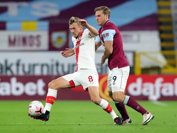 James Ward-Prowse of Southampton battles for possession with Chris Wood of Burnley during the Premier League match between Burnley and Southampton at Turf Moor on September 26, 2020 in Burnley, England.