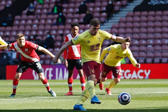 Burnley's New Zealand striker Chris Wood (C) shoots from the penalty spot to score his team's opening goal during the English Premier League football match between Southampton and Burnley at St Mary's Stadium in Southampton, southern England on April 4, 2021.