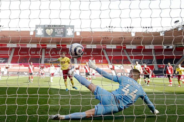 Burnley's New Zealand striker Chris Wood (C) scores his team's first goal from the penalty spot during the English Premier League football match between Southampton and Burnley at St Mary's Stadium in Southampton, southern England on April 4, 2021.
