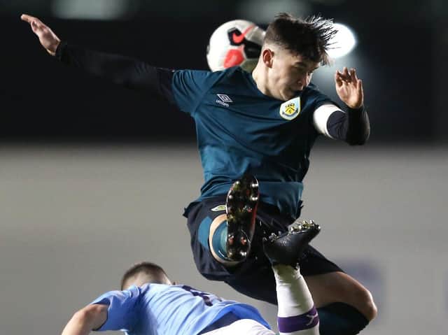 MANCHESTER, ENGLAND - MARCH 04: Joseph Hodge of Manchester City jumps for the ball with Chris Conn-Clarke of Burnley during the FA Youth Cup match between Manchester City and Burnley at The Academy Stadium on March 04, 2020 in Manchester, England. (Photo by Charlotte Tattersall/Getty Images)