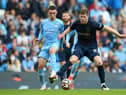 Phil Foden of Manchester City and Nathan Collins of Burnley battle for the ball during the Premier League match between Manchester City and Burnley at Etihad Stadium on October 16, 2021 in Manchester, England.