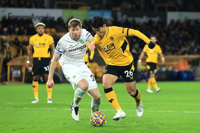 Hwang Hee-chan of Wolverhampton Wanderers is closed down by Nathan Collins of Burnley during the Premier League match between Wolverhampton Wanderers and Burnley at Molineux on December 01, 2021 in Wolverhampton, England.