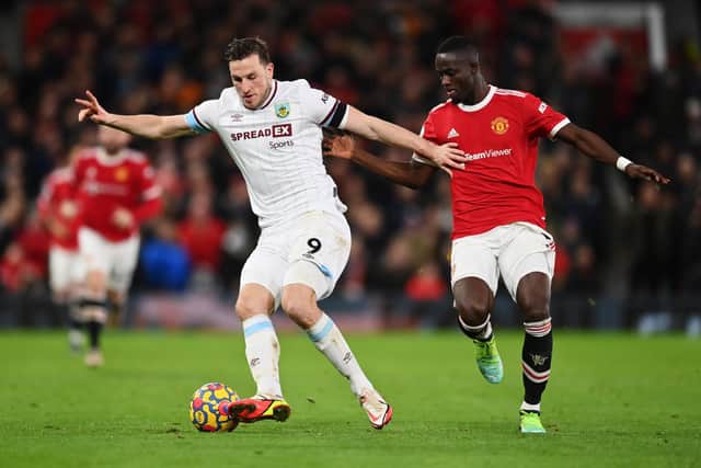 Chris Wood of Burnley holds off Eric Bailly of Manchester United during the Premier League match between Manchester United and Burnley at Old Trafford on December 30, 2021 in Manchester, England.