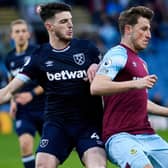 West Ham United's English midfielder Declan Rice (L) closes in on Burnley's New Zealand striker Chris Wood (R) during the English Premier League football match between Burnley and West Ham United at Turf Moor in Burnley, north west England on December 12, 2021.