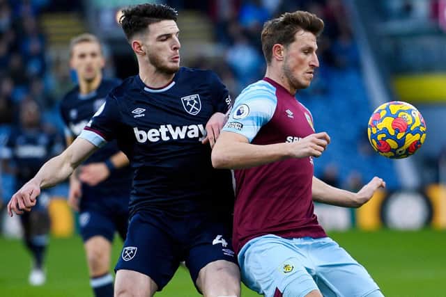 West Ham United's English midfielder Declan Rice (L) closes in on Burnley's New Zealand striker Chris Wood (R) during the English Premier League football match between Burnley and West Ham United at Turf Moor in Burnley, north west England on December 12, 2021.