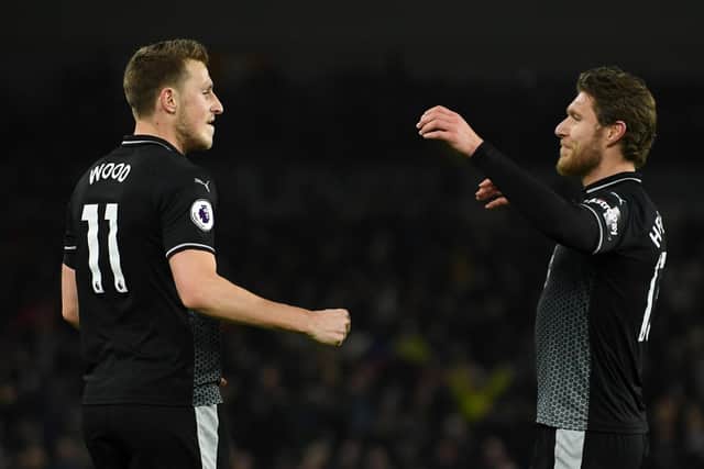 Chris Wood of Burnley celebrates with teammate Jeff Hendrick after scoring his team's first goal during the Premier League match between Brighton & Hove Albion and Burnley FC at American Express Community Stadium on February 9, 2019 in Brighton, United Kingdom.