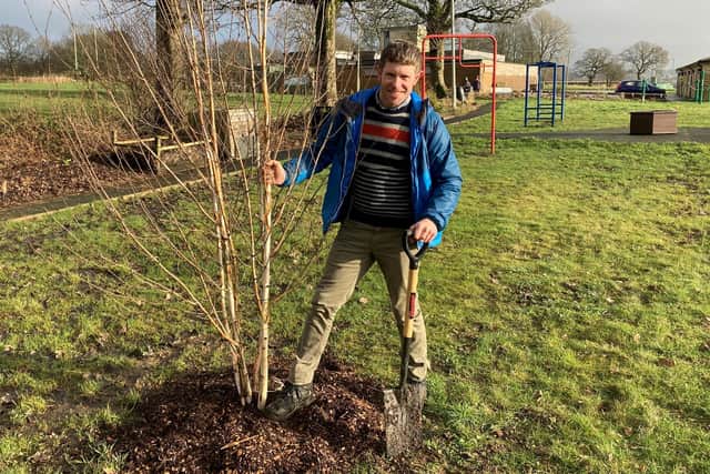 Phil Riley, Pendle Council's Green Spaces Manager, planting a new tree at Holt House in Colne