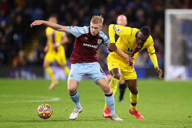 Ben Mee of Burnley battles for possession with Christian Benteke of Crystal Palace during the Premier League match between Burnley and Crystal Palace at Turf Moor on November 20, 2021 in Burnley, England.
