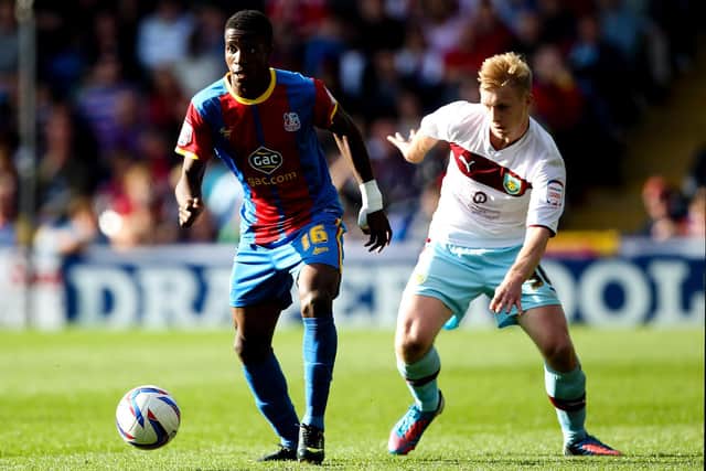 Wilfred Zaha of Crystal Palace in action with Ben Mee of Burnley during the npower Championship match between Crystal Palace and Burnley at Selhurst Park on October 6, 2012 in London, England.