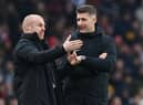 Burnley's English manager Sean Dyche (L) speaks with fourth official Robert Jones during the English Premier League football match between Arsenal and Burnley at the Emirates Stadium in London on January 23, 2022.