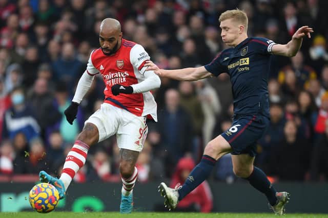 Alex Lacazette of Arsenal takes on Ben Mee of Burnley during the Premier League match between Arsenal and Burnley at Emirates Stadium on January 23, 2022 in London, England.