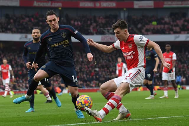 Kieran Tierney of Arsenal crosses under pressure from Connor Roberts of Burnley during the Premier League match between Arsenal and Burnley at Emirates Stadium on January 23, 2022 in London, England.
