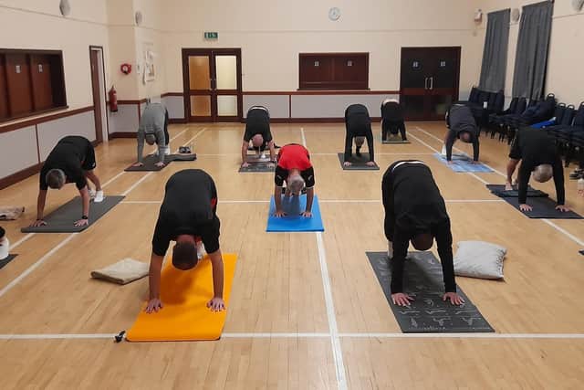 Being put through their paces - attendees at the men's Yoga For Sport class