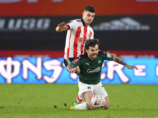 Dominic Telford of Plymouth Argyle is fouled by John Egan of Sheffield United during The Emirates FA Cup Fourth Round match between Sheffield United and Plymouth Argyle at Bramall Lane on January 23, 2021 in Sheffield, England.