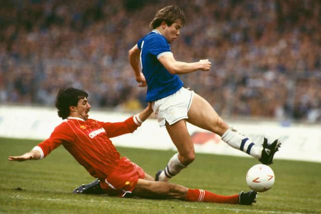Liverpool defender Mark Lawrenson slides in on Everton striker Adrian Heath during the 1984 Milk Cup Final at Wembley Stadium on March 25, 1984 in London, England.