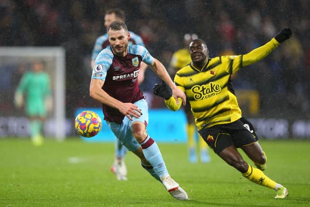 Erik Pieters of Burnley is challenged by Ken Sema of Watford FC during the Premier League match between Burnley and Watford at Turf Moor on February 05, 2022 in Burnley, England.