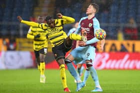 Wout Weghorst of Burnley is tackled by Hassane Kamara of Watford during the Premier League match between Burnley and Watford at Turf Moor on February 05, 2022 in Burnley, England.