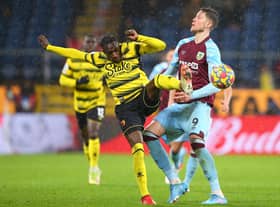 Wout Weghorst of Burnley is tackled by Hassane Kamara of Watford during the Premier League match between Burnley and Watford at Turf Moor on February 05, 2022 in Burnley, England.