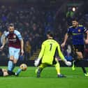 Jay Rodriguez of Burnley scores their team's first goal past Luke Shaw, David De Gea and Harry Maguire of Manchester United during the Premier League match between Burnley and Manchester United at Turf Moor on February 08, 2022 in Burnley, England.