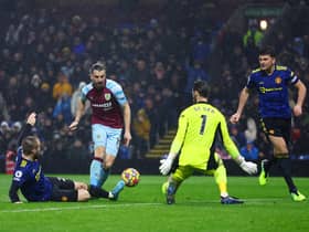 Jay Rodriguez of Burnley scores their team's first goal past Luke Shaw, David De Gea and Harry Maguire of Manchester United during the Premier League match between Burnley and Manchester United at Turf Moor on February 08, 2022 in Burnley, England.