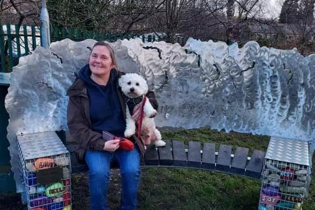 Vivien Storey with her dog Buddy on the friendship bench she raised £3,000 for