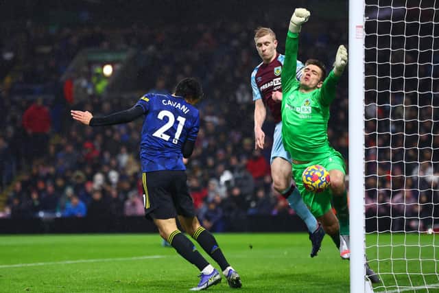 Nick Pope of Burnley saves a header from Edinson Cavani of Manchester United during the Premier League match between Burnley and Manchester United at Turf Moor on February 08, 2022 in Burnley, England.