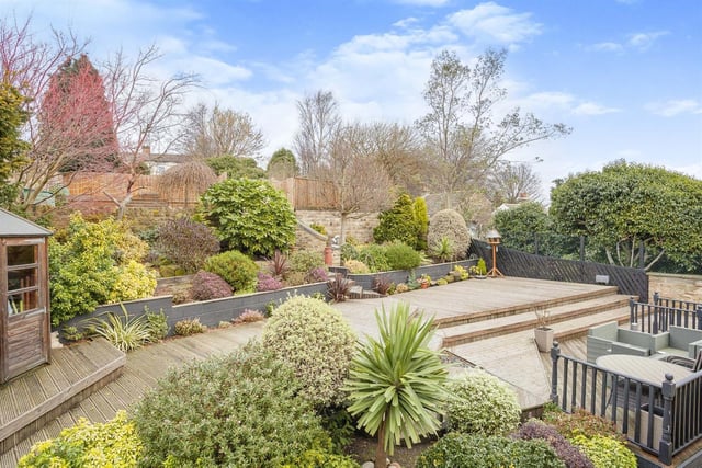 A tiered garden with numerous mixed shrubs, plants and trees is a delight.