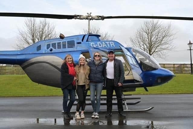 Laura (second from right) and her mum and sister with local businessman Dave Fishwick who helped her achieve one of her 'bucket list' dreams by flying her in his helicopter