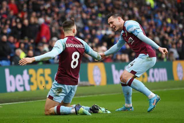 Josh Brownhill of Burnley celebrates after scoring their side's second goal with Connor Roberts of Burnley during the Premier League match between Brighton & Hove Albion and Burnley at American Express Community Stadium on February 19, 2022 in Brighton, England.
