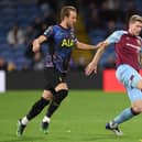 Nathan Collins of Burnley battles for possession with Harry Kane of Tottenham Hotspur during the Carabao Cup Round of 16 match between Burnley and Tottenham Hotspur at Turf Moor on October 27, 2021 in Burnley, England.
